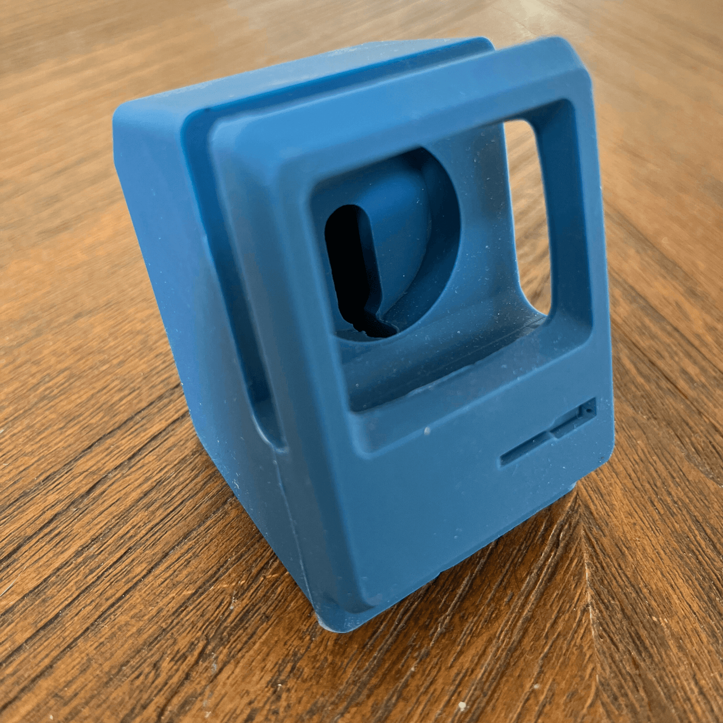 Retro blue silicone cradle designed for Apple Watch, resembling an old office computer.
