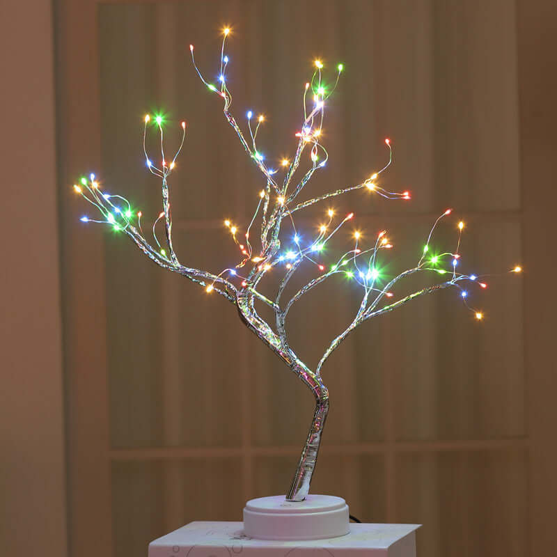 Colorful LED wire tree sculpture with intricate branches illuminating a cozy space.