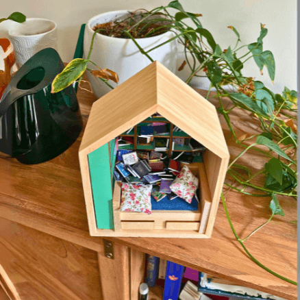 Miniature Anxiety Book Room bookshelf with tiny books, bed, and pillows, perfect sensory gift for organization and decor.