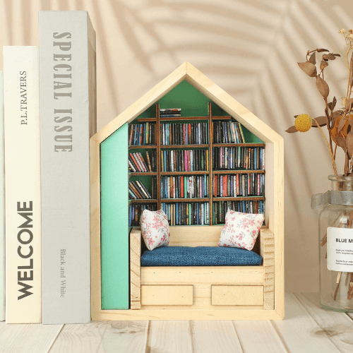 Wooden house-shaped bookshelf featuring cozy seating and miniature books, perfect for organizing anxiety books.