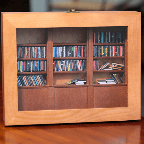 Miniature bookshelf display showcasing a variety of colorful books, perfect for the Anxiety Bookshelf Collection.
