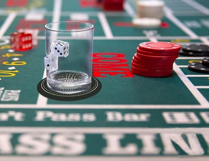 Close-up of a Dice Embedded Hand Blown Glass Cup on a casino table with chips and dice.