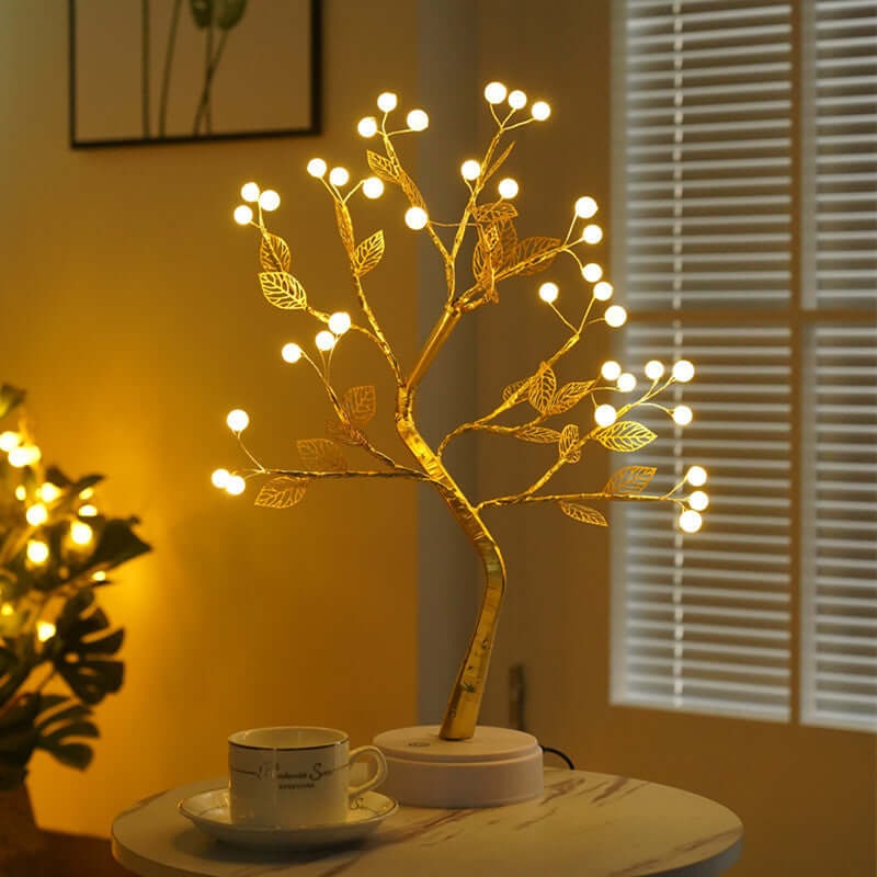 Handcrafted wire tree sculpture with LED lights creating a warm ambiance, perfect for home decor.