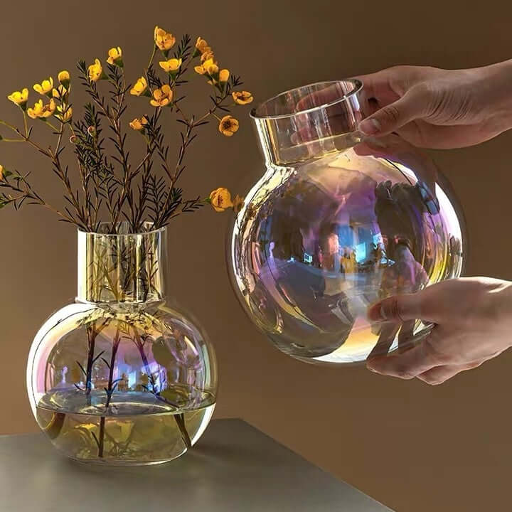 Iridescent color-shifting glass orb vases with flowers, showcasing a magical rainbow effect.