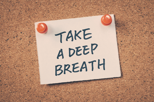 A note is pinned to a board that reads: Take a Deep Breath.