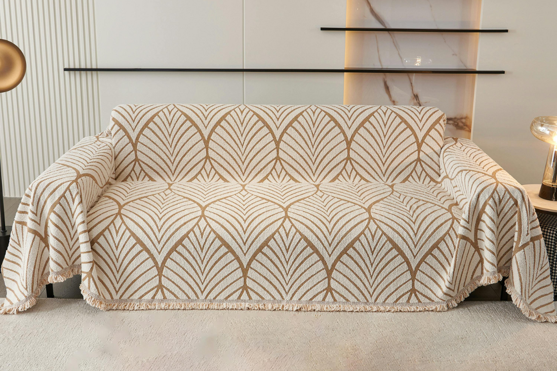 A loose-fitting, thick fabric couch slipcover is displayed on a three seater couch.