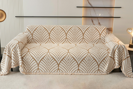 A loose-fitting, thick fabric couch slipcover is displayed on a three seater couch.