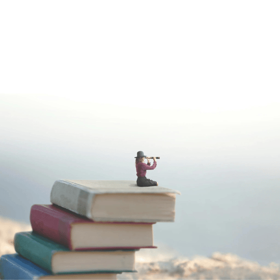 A tiny human sits on a stack of giant books, looking through binoculars over a clifftop.