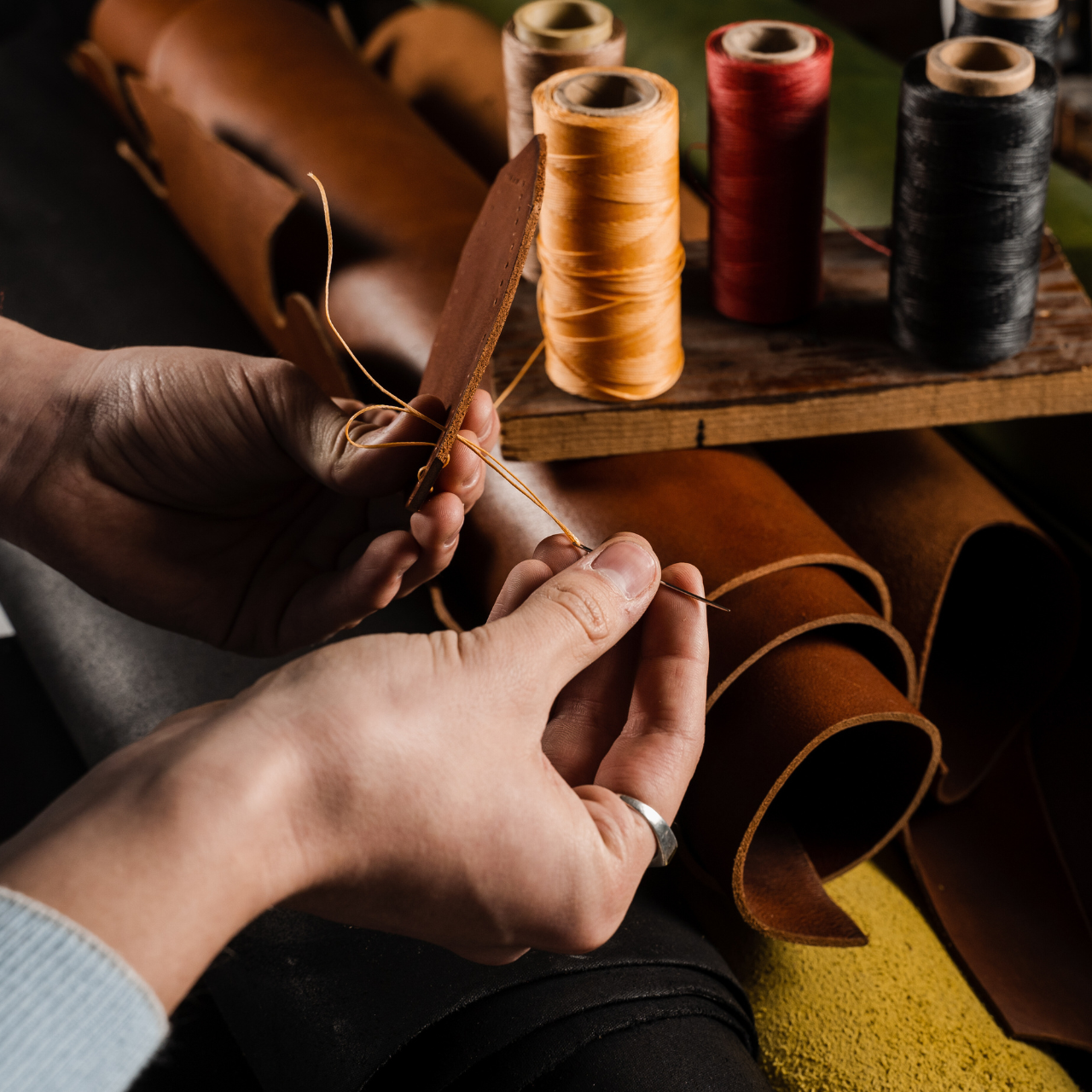 Dark brown leather is stitched by hand.