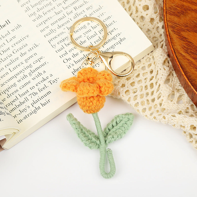 Handmade crochet flower keychain featuring a yellow tulip with green stem, perfect gift for flower lovers.