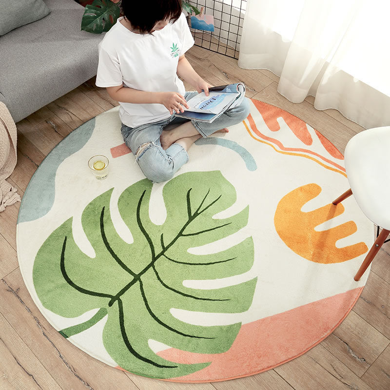 Round area rug with a monstera over a pastel boho pattern.