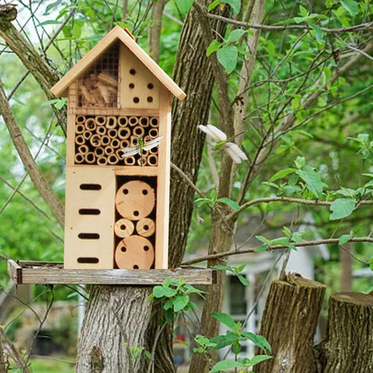 A handmade wood insect hotel sits outdoors awaiting bugs to make its home.