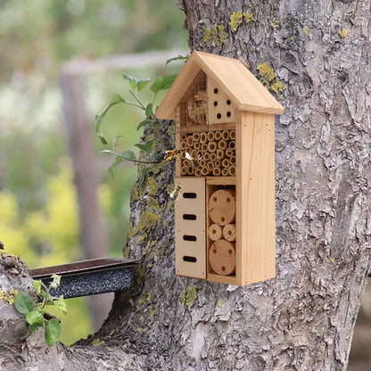 A handmade wood insect hotel sits outdoors awaiting bugs to make its home.