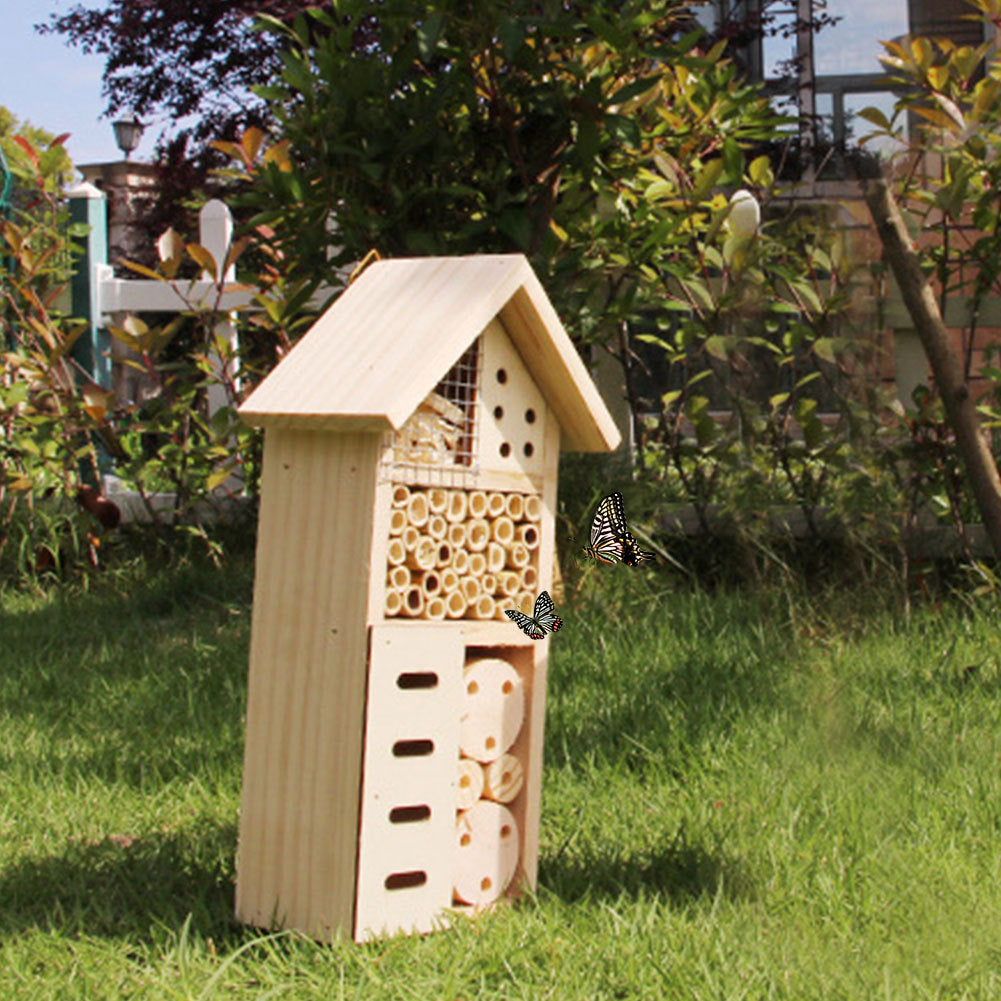 A handmade wood insect hotel sits outdoors awaiting bugs to make its home.