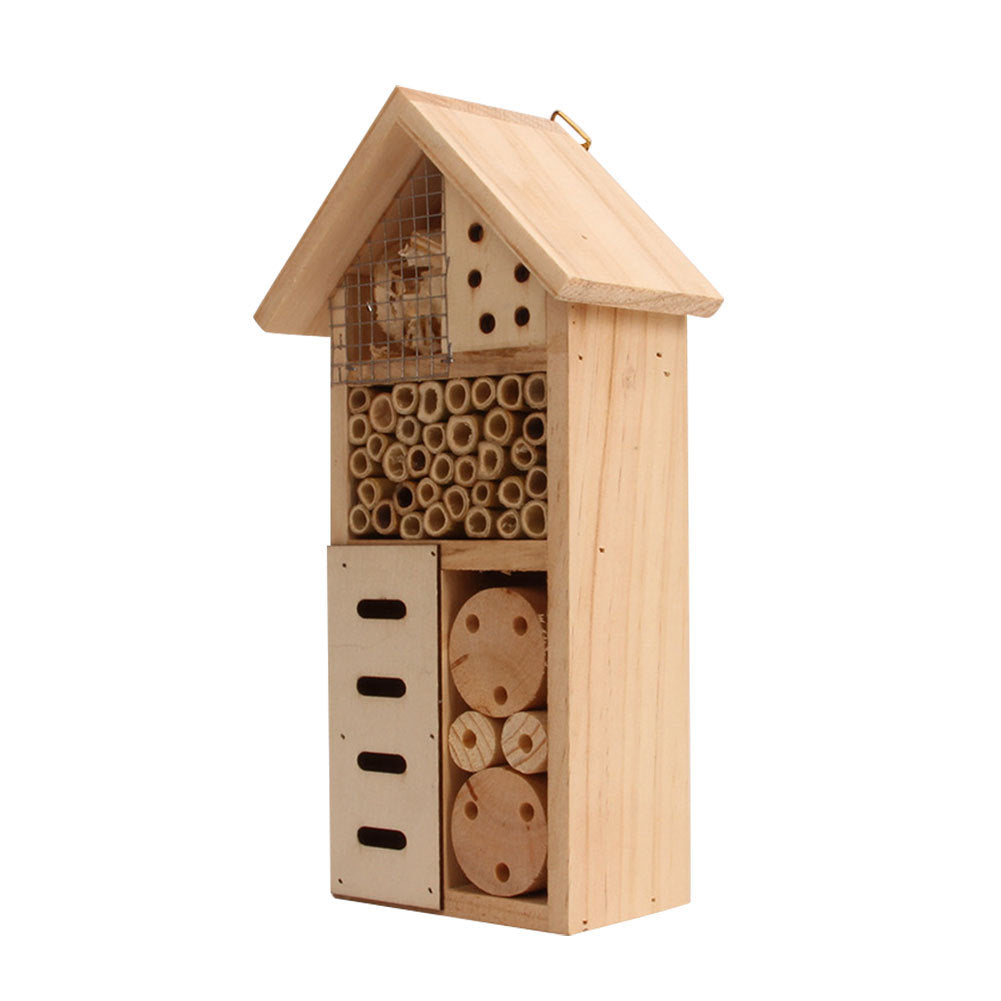 A handmade wood insect hotel sits outdoors awaiting bugs to make its home.