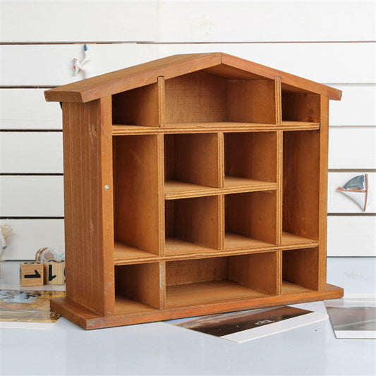 Wood floating shelf that is shaped like a house. It features twelve compartments in a rack style storage area.