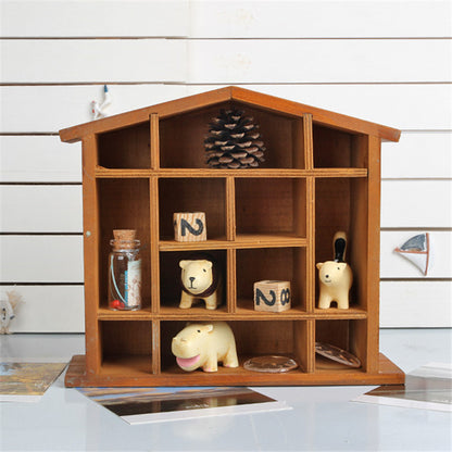 Wood floating shelf that is shaped like a house. It features twelve compartments in a rack style storage area.