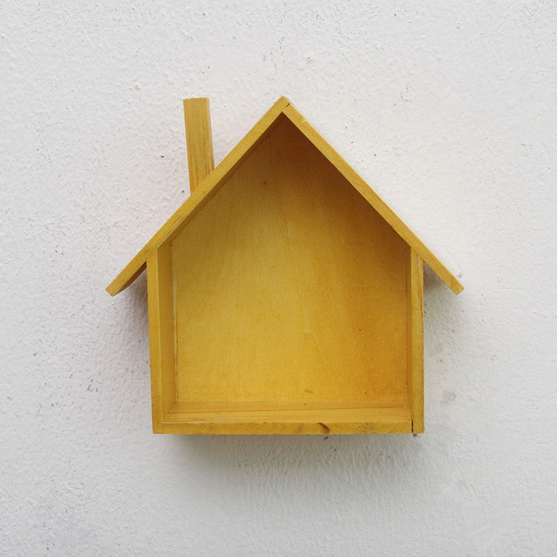 A handmade house shaped floating bookshelf available in green, white, gold, red, pink, and blue.