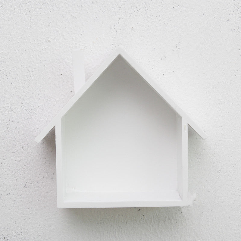 A handmade house shaped floating bookshelf available in green, white, gold, red, pink, and blue.