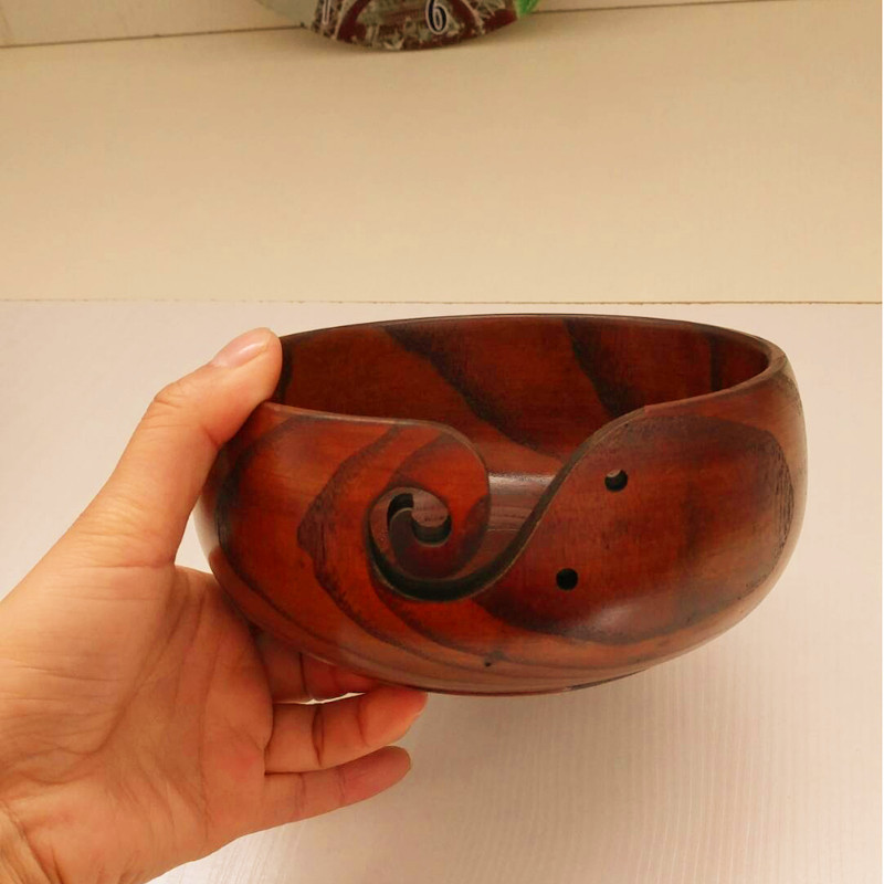 Hand carved crochet yarn bowls in a dark golden wood stain.