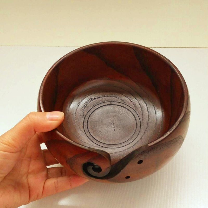 Hand carved crochet yarn bowls in a dark golden wood stain.