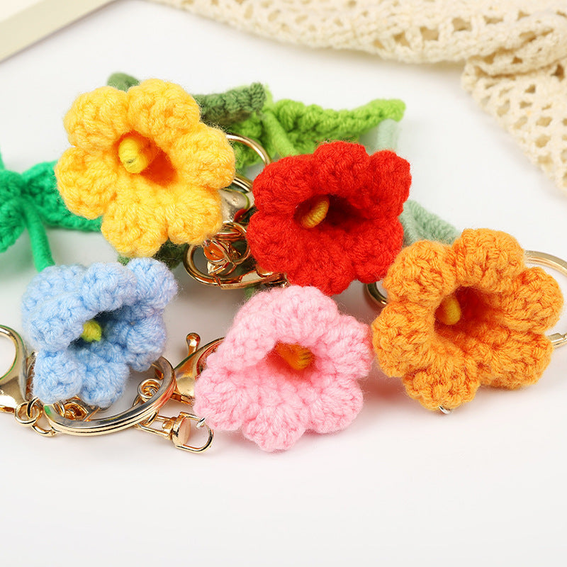 Handmade crochet flower keychains in colorful tulip designs, featuring yellow, red, blue, pink, and orange blooms.