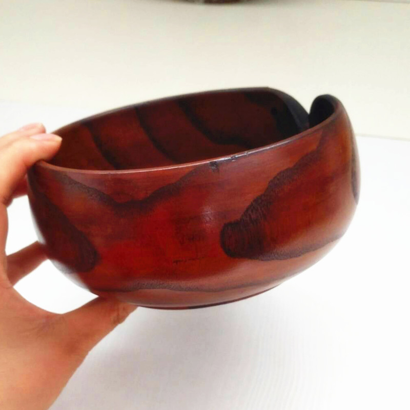 Hand carved crochet yarn bowls in a dark golden wood stain.