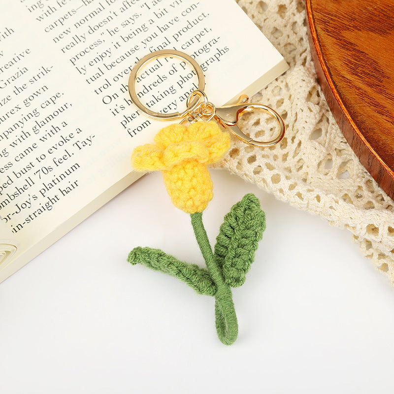 Handmade crochet flower keychain in yellow with green stem, perfect gift for flower lovers.