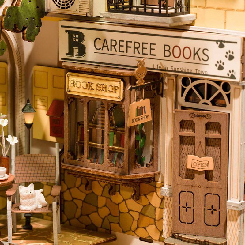 A close up of a miniature coffee shop inside of the book nook.