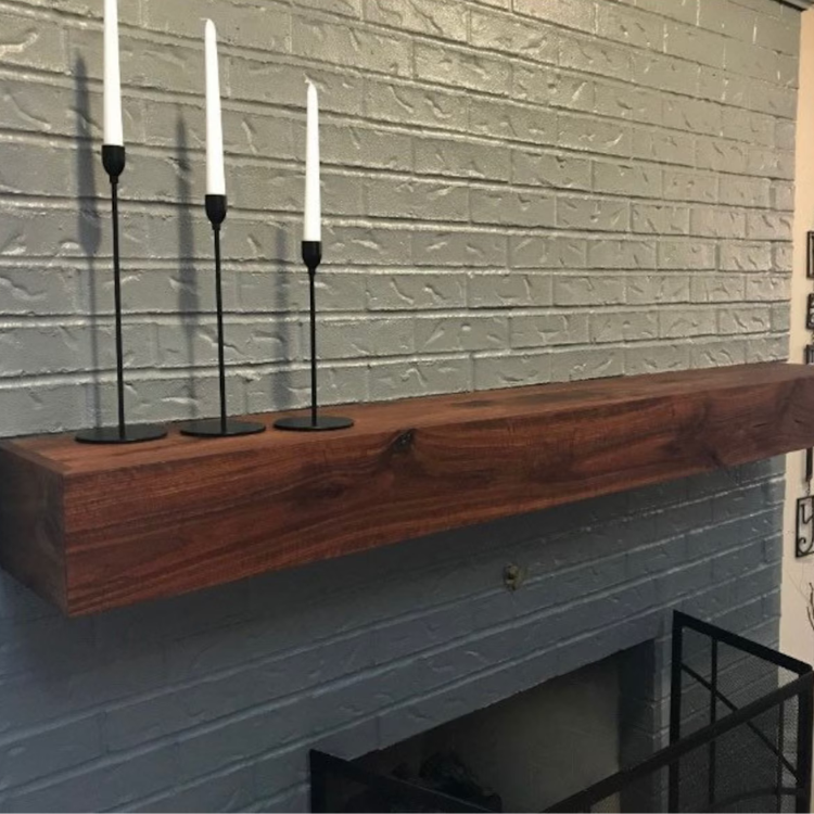 Natural wood grain is featured in this dark stained floating mantel cover.