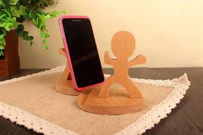 Wooden animal-shaped phone stand holding a smartphone, featuring a playful stick figure design.