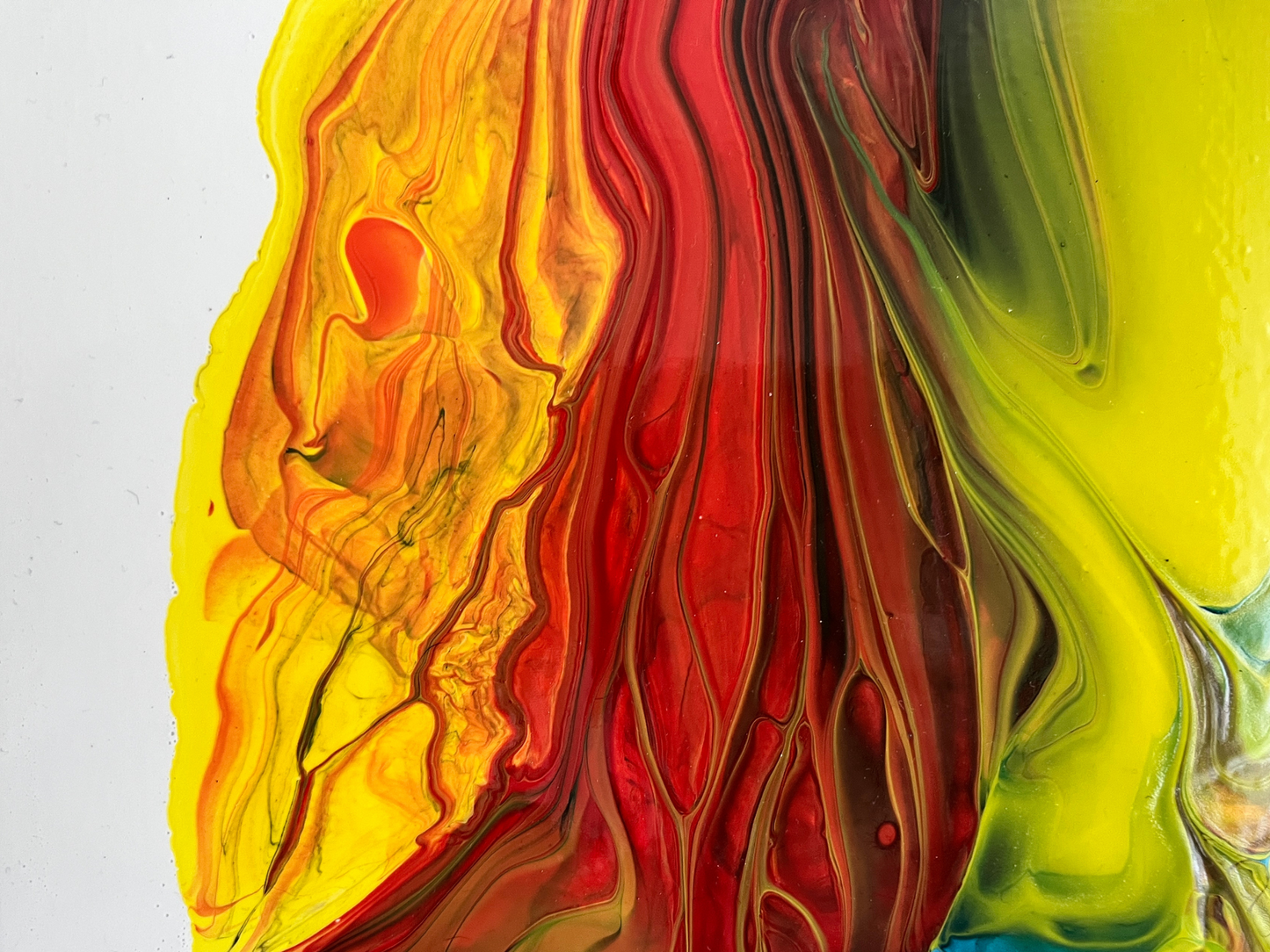 red, yellow and blue fluid art painting on canvas representing fire and ice