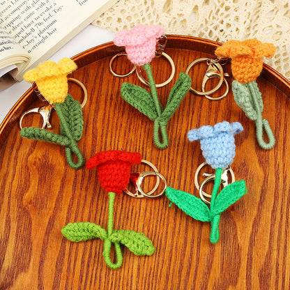 Handmade crochet flower keychains in various colors, showcasing tulips with stems, perfect for unique gifts.