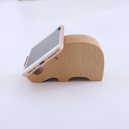 Wood animal shaped phone stand featuring a cute elephant design, perfect for holding smartphones.