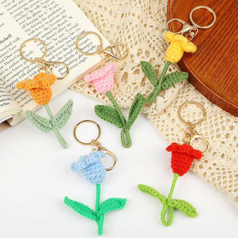 Handmade crochet flower keychains in assorted colors, showcasing tulips attached to keyrings.