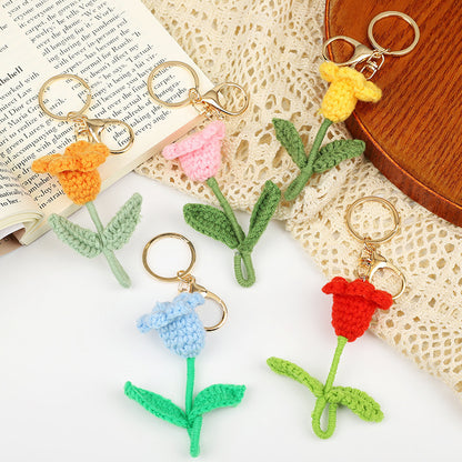 Handmade crochet flower keychains in assorted colors, showcasing tulips attached to keyrings.