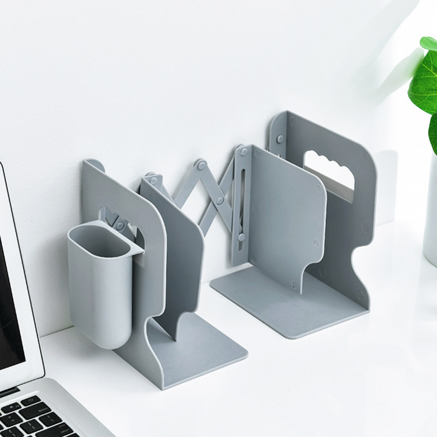 Grey retractable bookends are displayed. A single unit with an accordion style mechanism that allows the bookends to adjust.