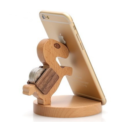 Wood animal shaped phone stand featuring a playful dinosaur design, holding a phone securely and stylishly.