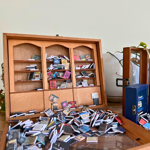 Open displaying tiny books. The Anxiety Bookshelf, Pocket Anxiety Bookshelf, and the Anxiety Bookcase.