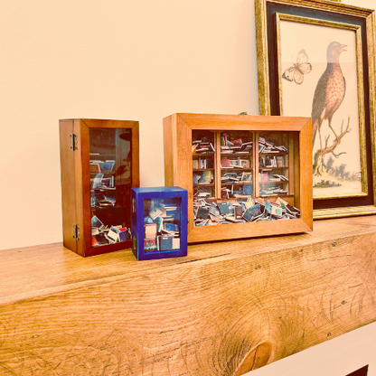 Anxiety Bookshelf mini bookshelf collection sits on a mantel shelf.