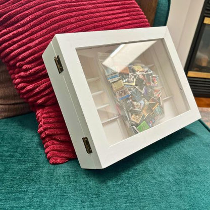 A White Anxiety Bookshelf with books sits on display. The mini book box shake shelf for anxiety.