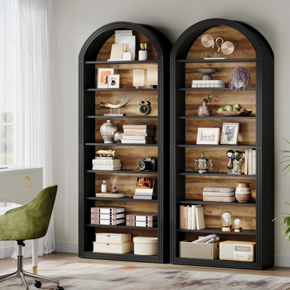 A tall and narrow black arched top bookshelf with wood grain backing. An open faced unique bookshelf for tight spaces.