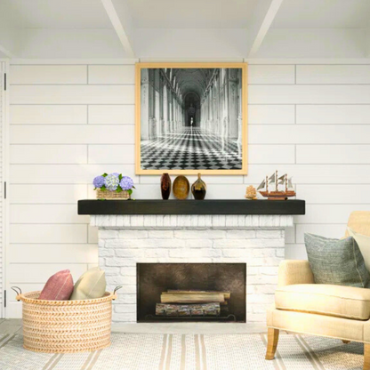 Black stained mantel slipcover sits on a white brick surrounded fireplace.