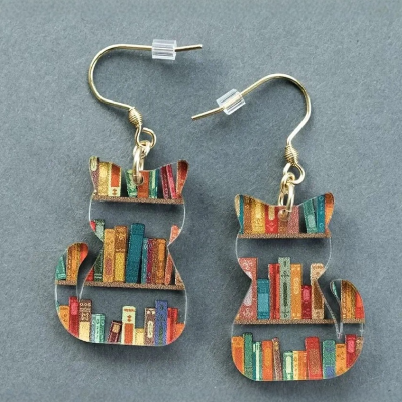 Clear acrylic cat shaped mini bookshelf earrings with colourful books inside.