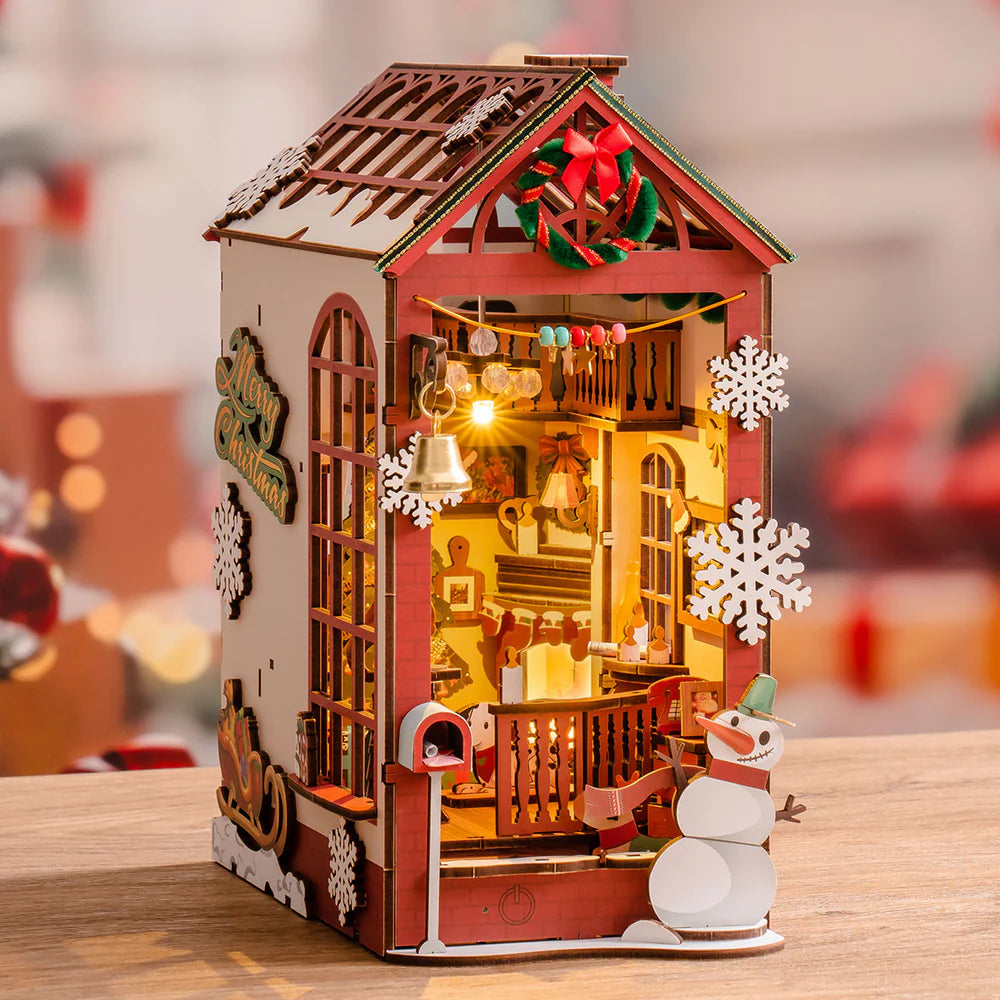 An illuminated christmas themed book nook is displayed.