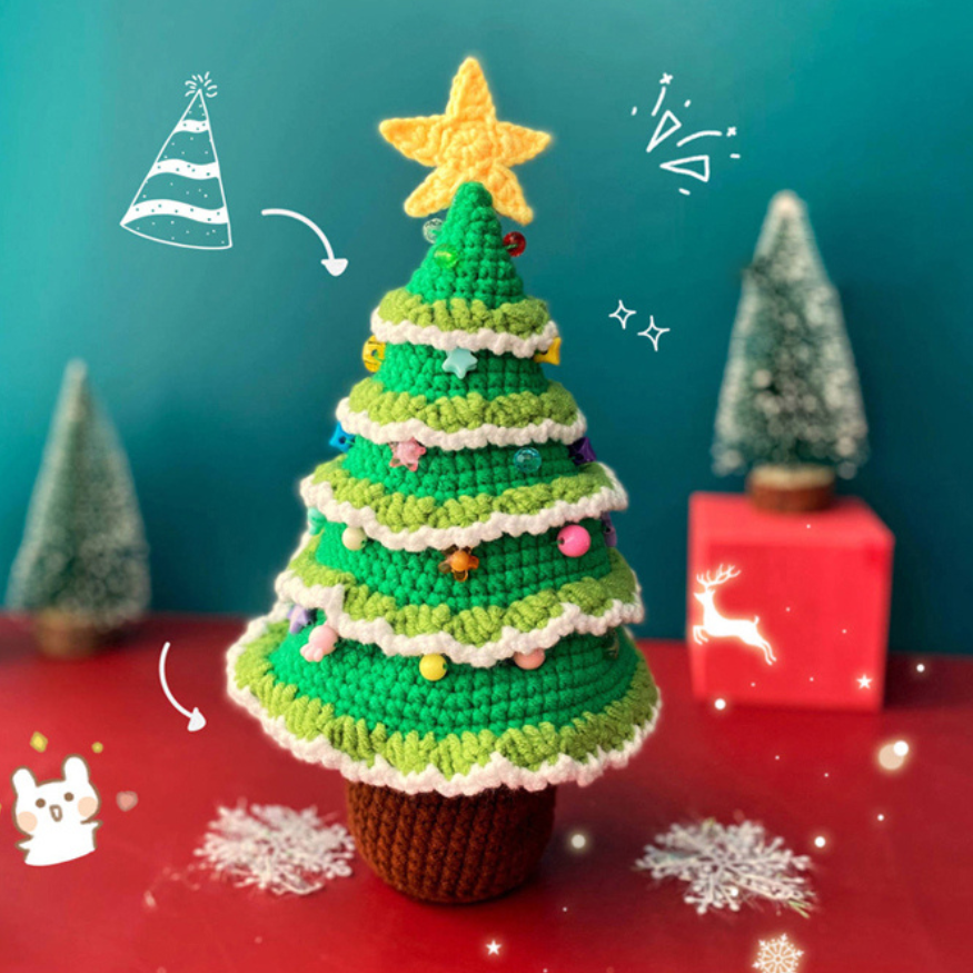 Handmade crochet christmas tree plushie is displayed over a red and green holiday background. The christmas tree has a star on the top.