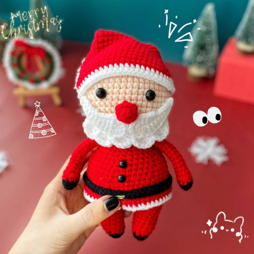 Handmade crochet santa clause plushie is displayed.