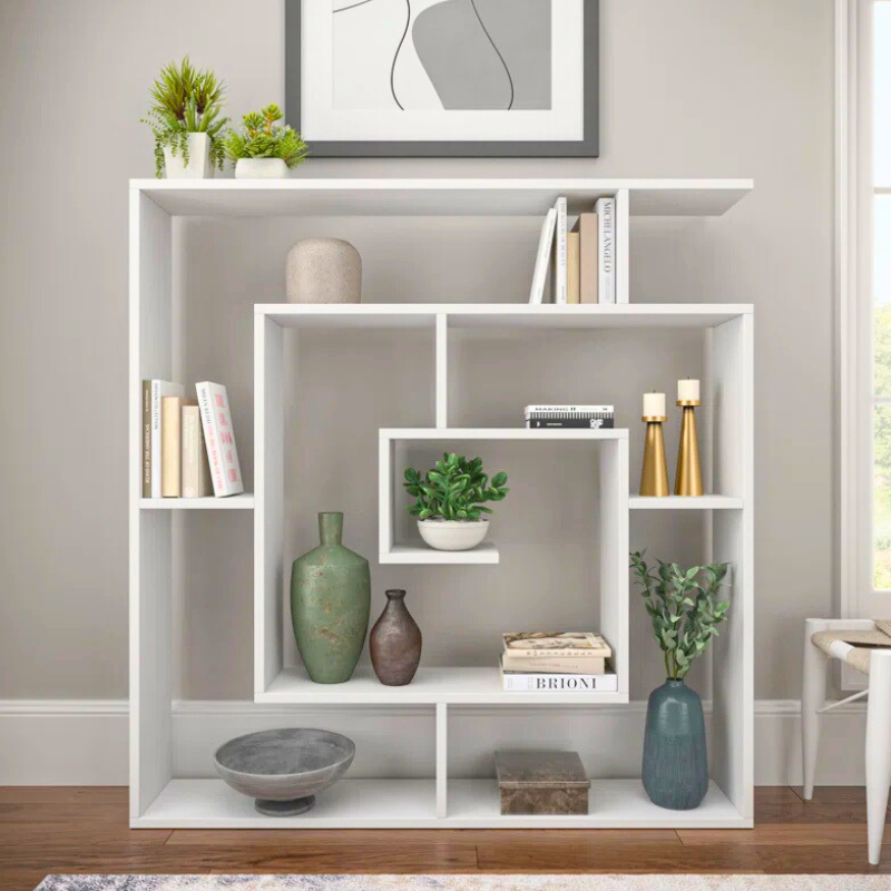 A spiralling square bookshelf is displayed. The geometric Fibonacci sequence shape of this unique bookshelf creates an artistic white bookcase. 