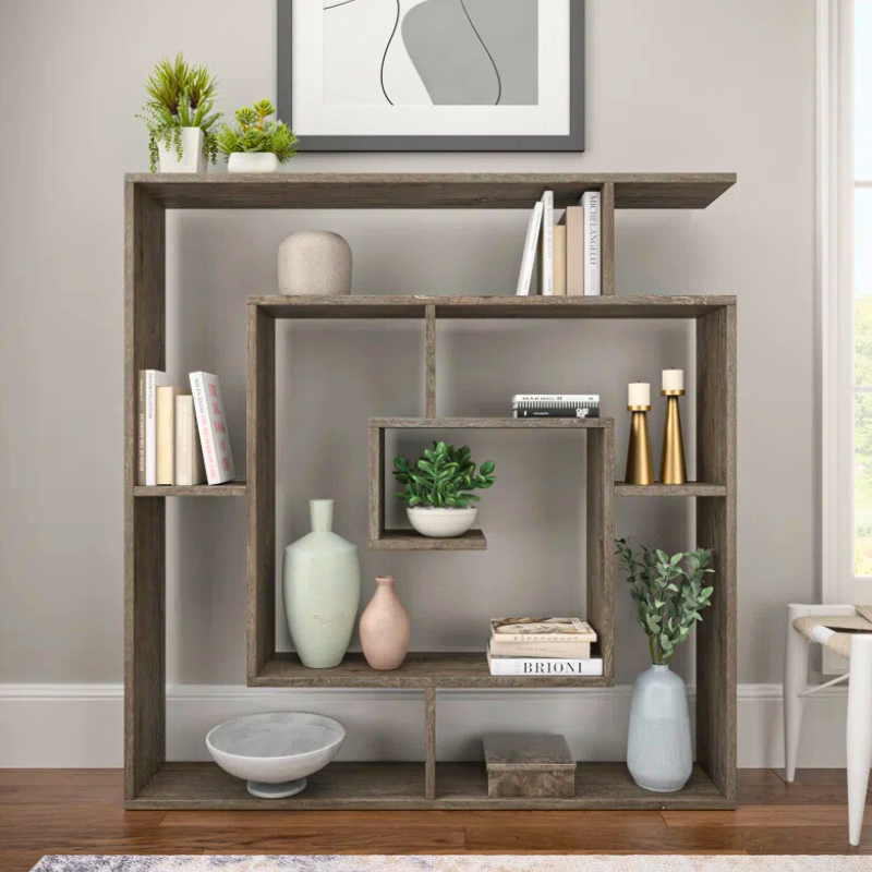 A spiralling square bookshelf is displayed. The geometric Fibonacci sequence shape of this unique bookshelf creates an artistic bookcase with a dark wood finish.