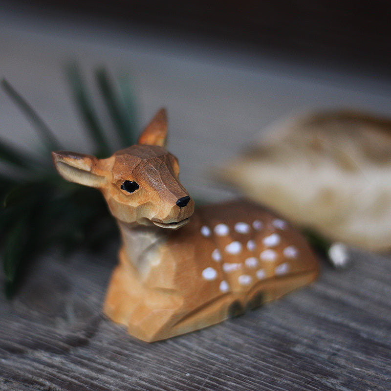 A hand carved baby deer calf ornament is imaged, uniquely painted by hand.